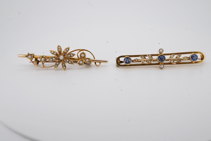 An Edwardian 9ct, sapphire and seed pearl set bar brooch, 43mm, gross weight 2.6 grams, together with a similar 15ct and seed pearl cluster set bar brooch, gross weight 2.9 grams. Condition - fair to good